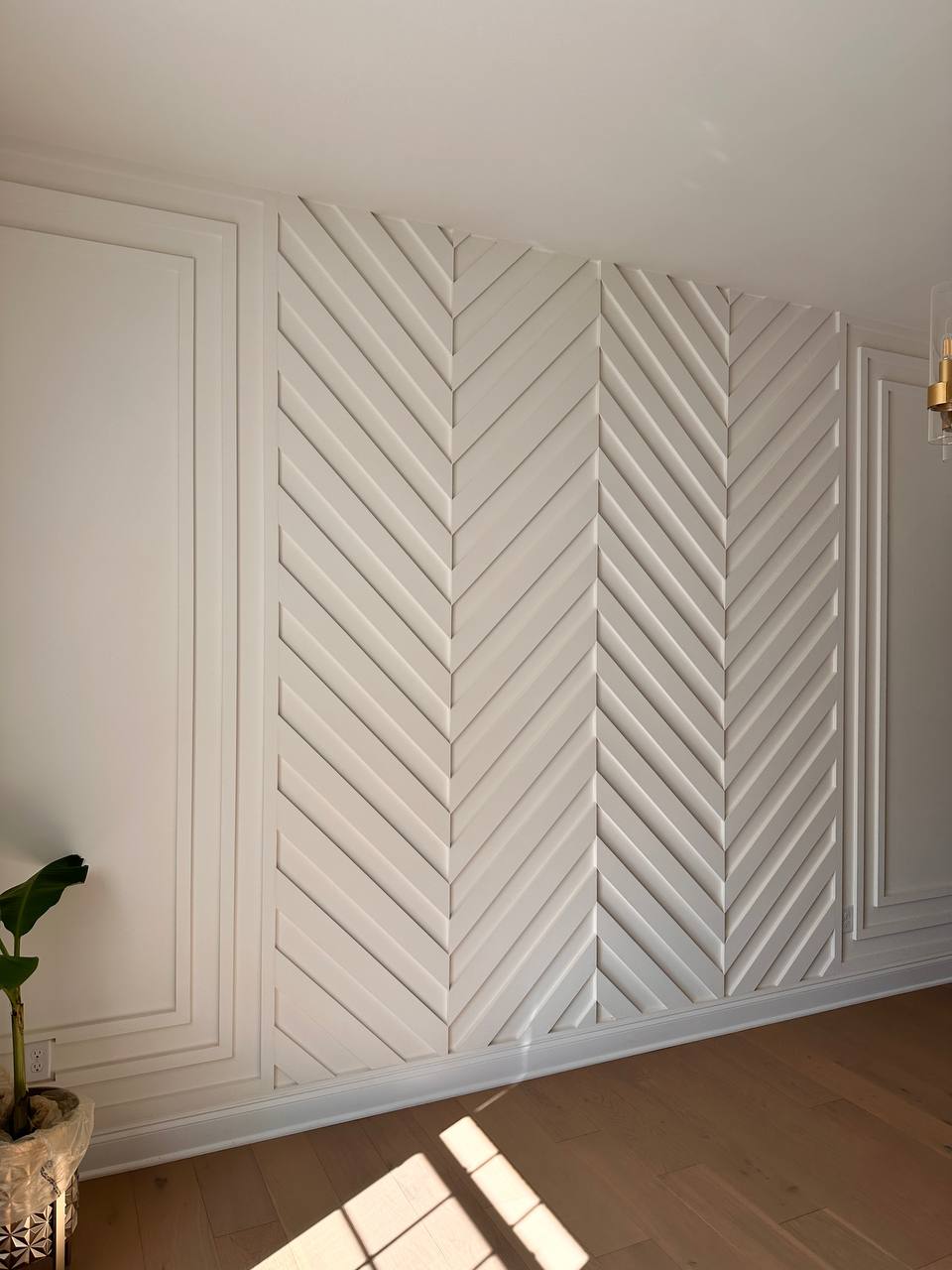 White chevron panel accent wall in elegant bedroom